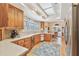 Open kitchen layout with light wood cabinetry, white countertops, and dining area in view at 4309 W Robin Ln, Tampa, FL 33609