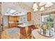 Bright kitchen featuring a skylight and windows for natural light, white countertops, and wood cabinets at 4309 W Robin Ln, Tampa, FL 33609