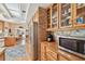 Bright kitchen with wood cabinetry, stainless steel refrigerator, and adjacent dining area at 4309 W Robin Ln, Tampa, FL 33609