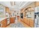Charming kitchen showcasing a brick arch, wood cabinets, and stainless steel appliances at 4309 W Robin Ln, Tampa, FL 33609