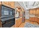 Spacious kitchen featuring light wood cabinets and stainless steel appliances, with a brick arch focal point at 4309 W Robin Ln, Tampa, FL 33609