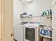 Laundry room with washer, dryer, and washing sink at 4309 W Robin Ln, Tampa, FL 33609