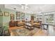 Spacious living room with hardwood floors, coffered ceilings, and plentiful windows at 4309 W Robin Ln, Tampa, FL 33609