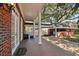 Covered brick patio with view of backyard, perfect for relaxing and enjoying the outdoors at 4309 W Robin Ln, Tampa, FL 33609