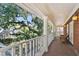 Exterior view of a porch featuring brick flooring, white columns, and views of the surrounding greenery at 4309 W Robin Ln, Tampa, FL 33609