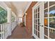 Inviting porch with brick flooring, white columns, and wicker chairs for relaxing outdoors at 4309 W Robin Ln, Tampa, FL 33609