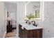 Well lit double vanity bathroom with quartz countertop and modern fixtures with a connecting bedroom at 4507 Fox Hunt Dr, Tampa, FL 33624