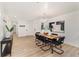Modern dining area featuring a wooden table, black chairs, contemporary lighting, and stylish decor at 4507 Fox Hunt Dr, Tampa, FL 33624