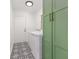 Bright laundry room featuring modern appliances, stylish tile flooring, and ample storage with green cabinetry at 4507 Fox Hunt Dr, Tampa, FL 33624