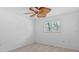 Bedroom with neutral carpet, ceiling fan, and a window with plantation shutters at 4531 44Th S St, St Petersburg, FL 33711