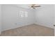 Bedroom with neutral carpet, ceiling fan, and a window overlooking the backyard at 4531 44Th S St, St Petersburg, FL 33711