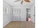 Bedroom features a ceiling fan, closet, and a window overlooking the backyard at 4531 44Th S St, St Petersburg, FL 33711