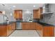 Modern kitchen featuring sleek wooden cabinets, stainless steel appliances, and stylish granite countertops at 4531 44Th S St, St Petersburg, FL 33711