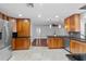 Bright kitchen with stainless steel refrigerator, granite countertops, wood cabinets and access to the living area at 4531 44Th S St, St Petersburg, FL 33711