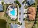 Aerial view of the community pool, cabanas, townhomes, and parking lot at 4730 Wandering Way, Wesley Chapel, FL 33544