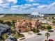 Aerial view of townhomes showcases lush landscaping, brick driveways, and proximity to a hospital at 4730 Wandering Way, Wesley Chapel, FL 33544