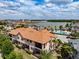 Beautiful aerial view of townhomes near a lake and community pool with cabanas at 4730 Wandering Way, Wesley Chapel, FL 33544
