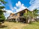 Townhome with a screened in patio and balcony overlooking a well-maintained backyard at 4730 Wandering Way, Wesley Chapel, FL 33544