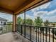 Relaxing balcony overlooking lush greenery and blue sky, offering an ideal outdoor living space at 4730 Wandering Way, Wesley Chapel, FL 33544