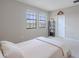 Bright and airy bedroom with plush carpet and ample natural light, complete with simple decorations at 4730 Wandering Way, Wesley Chapel, FL 33544