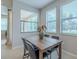 Bright dining space has a sleek wooden table, modern chairs, and natural light at 4730 Wandering Way, Wesley Chapel, FL 33544