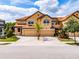 Attractive two-story townhome with a brick driveway and well-maintained landscaping at 4730 Wandering Way, Wesley Chapel, FL 33544
