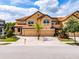 Attractive two-story townhome with a brick driveway and well-maintained landscaping at 4730 Wandering Way, Wesley Chapel, FL 33544