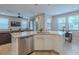 Open kitchen featuring a large island, stainless steel dishwasher and eat in dining area at 4730 Wandering Way, Wesley Chapel, FL 33544