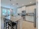 Stylish kitchen with stainless steel appliances, granite counter tops, and bright white cabinets at 4730 Wandering Way, Wesley Chapel, FL 33544