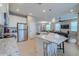 Modern kitchen featuring a large island with seating that flows into the living room at 4730 Wandering Way, Wesley Chapel, FL 33544