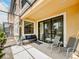 A covered lanai with seating, providing an outdoor space to relax and enjoy the backyard view at 4730 Wandering Way, Wesley Chapel, FL 33544