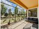 A screened lanai featuring shade, string lights and comfortable seating, perfect for relaxing and entertaining at 4730 Wandering Way, Wesley Chapel, FL 33544