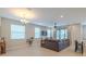 The open living area features a stylish ceiling fan, ample natural light, and a spacious layout for entertaining at 4730 Wandering Way, Wesley Chapel, FL 33544