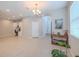 Bright living room with tile flooring, modern lighting and built-in desk area offers a flexible living space at 4730 Wandering Way, Wesley Chapel, FL 33544