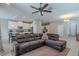 This spacious living room features an open layout, connecting to a modern kitchen and a dedicated workspace at 4730 Wandering Way, Wesley Chapel, FL 33544