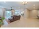 Spacious living room boasts recessed lighting, tile floors, and seamless access to the kitchen at 4730 Wandering Way, Wesley Chapel, FL 33544