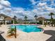 Community pool featuring cabanas, ample lounge seating, and lush landscaping at 4730 Wandering Way, Wesley Chapel, FL 33544