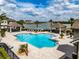 Community pool featuring cabanas, ample lounge seating, and lush landscaping at 4730 Wandering Way, Wesley Chapel, FL 33544