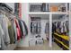 Organized walk-in closet with ample shelving and hanging space for efficient storage solutions at 4730 Wandering Way, Wesley Chapel, FL 33544