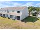 Aerial view of the townhouse back exterior with screened-in patios and well-kept lawn at 5084 Misty Canal Pl, Bradenton, FL 34203