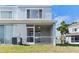 View of the screened-in patio with fan, access door, and nearby palm trees at 5084 Misty Canal Pl, Bradenton, FL 34203