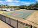 Community basketball court surrounded by a black fence at 5084 Misty Canal Pl, Bradenton, FL 34203