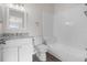Bright bathroom features a white vanity with granite counters and tub with white tiled walls at 5084 Misty Canal Pl, Bradenton, FL 34203
