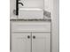 Bathroom vanity featuring modern faucet, granite countertop and white cabinet at 5084 Misty Canal Pl, Bradenton, FL 34203