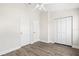 Bedroom with ceiling fan, closet, and door at 5084 Misty Canal Pl, Bradenton, FL 34203