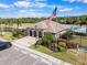 View of the community clubhouse, swimming pool, and the American flag at 5084 Misty Canal Pl, Bradenton, FL 34203