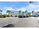 Charming multi-colored townhomes with palm trees and ample parking on a sunny day at 5084 Misty Canal Pl, Bradenton, FL 34203