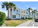 A row of beautiful townhomes showcases well-manicured lawns and mature palm trees at 5084 Misty Canal Pl, Bradenton, FL 34203