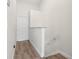 Hallway with wood floors leading to stairs and a door at 5084 Misty Canal Pl, Bradenton, FL 34203
