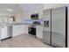 Modern kitchen with stainless steel appliances, white cabinets, and granite countertops at 5084 Misty Canal Pl, Bradenton, FL 34203